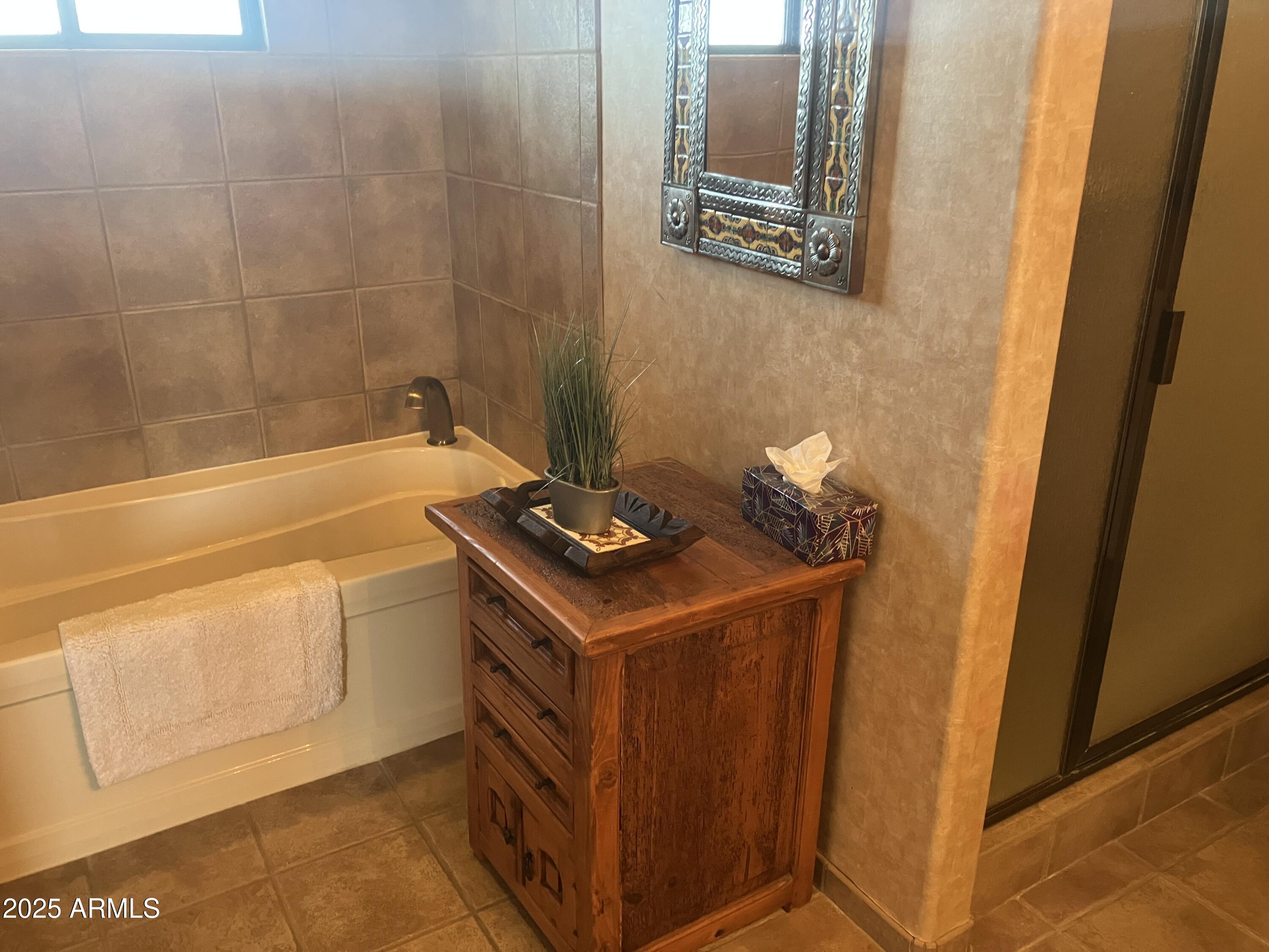 36601 North Mule Train Road, Unit 12C Carefree, AZ 85377 - Photo 28 of 42 a bathroom with a sink and a bath tub