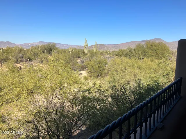 a dining room with furniture and a kitchen view