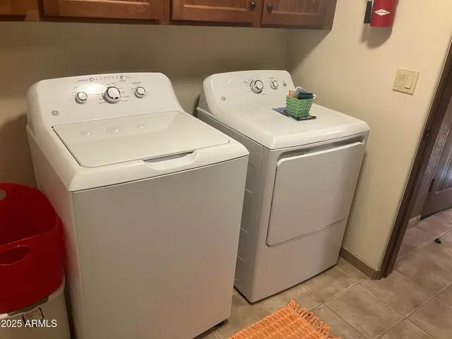 a view of a swimming pool with a patio and a yard