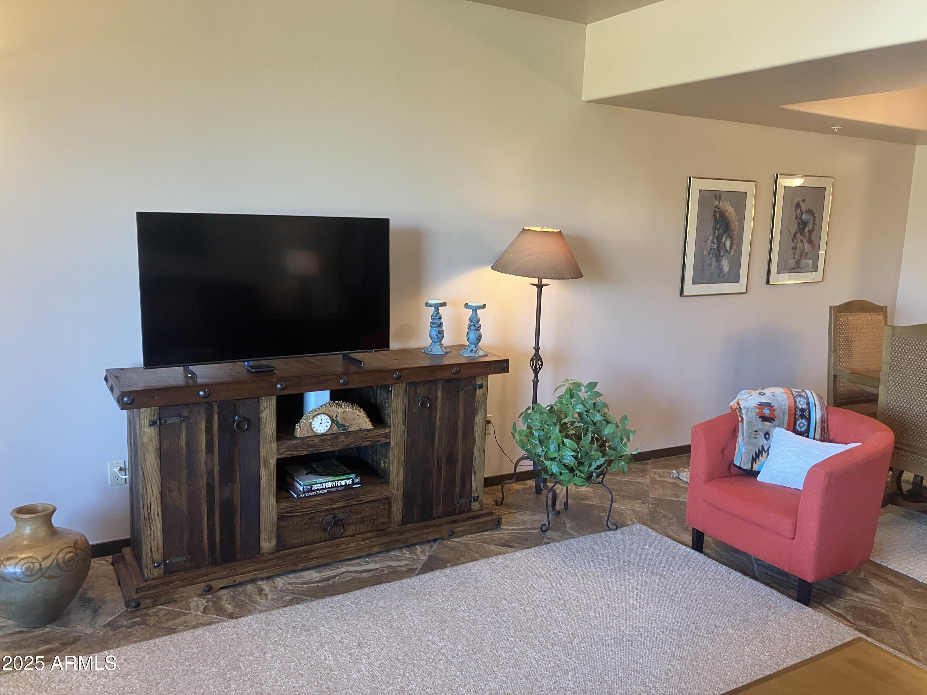 36601 North Mule Train Road, Unit 12C Carefree, AZ 85377 - Photo 10 of 42 a living room with furniture and a flat screen tv