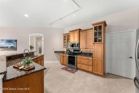 a kitchen with a stove a sink and a refrigerator