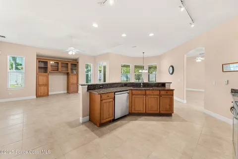 a large kitchen with a large counter top and stainless steel appliances