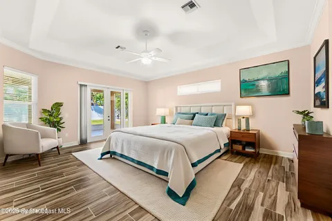 a bedroom with a large bed a flat screen tv and a couch