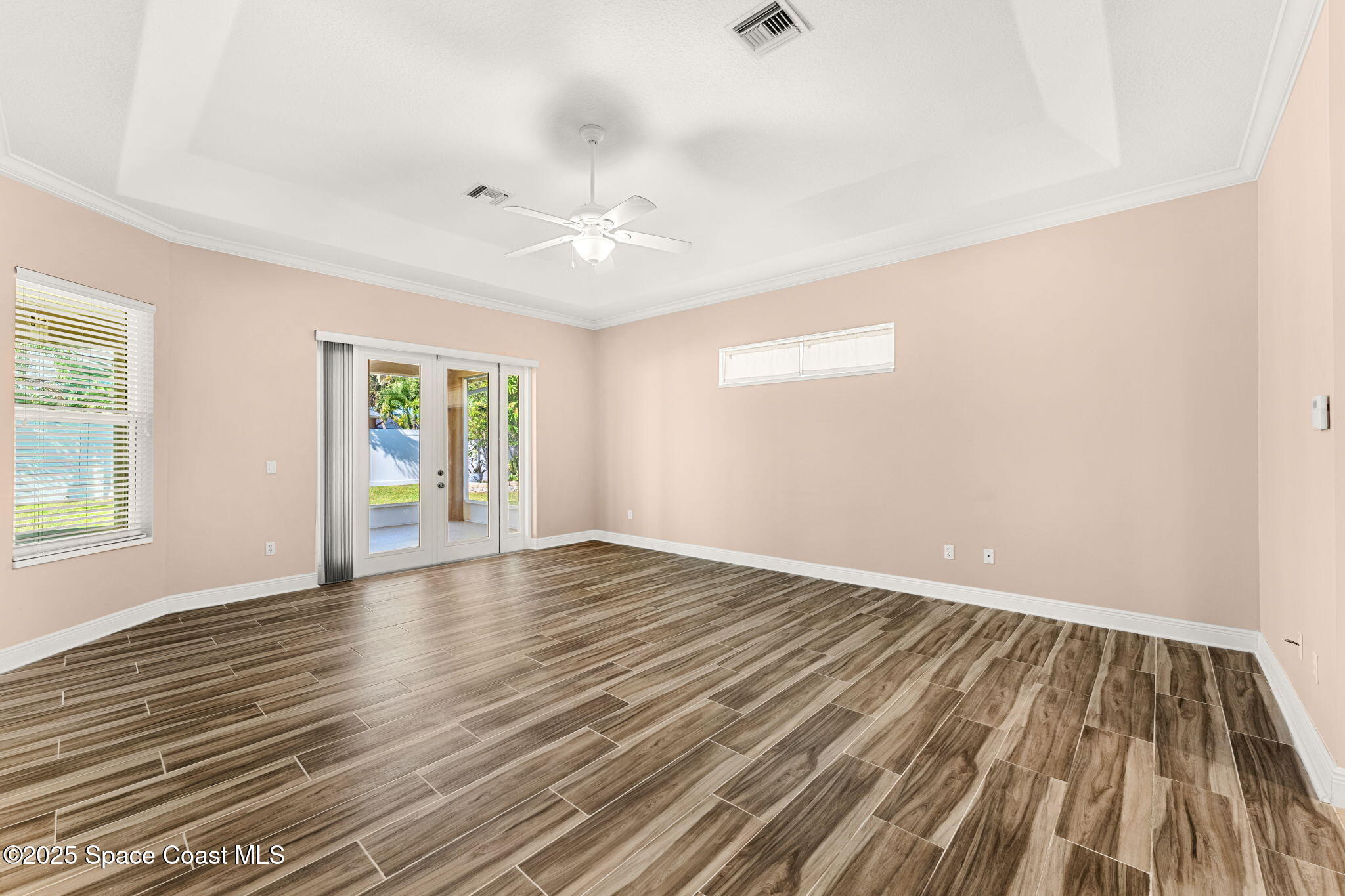 1239 Guy Island Drive Merritt Island, FL 32952 - Photo 15 of 42 an empty room with wooden floor and windows