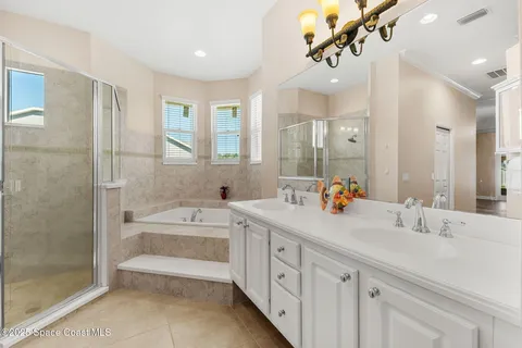 a bathroom with a double vanity sink mirror double and bathtub