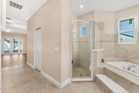a bathroom with a tub shower and sink