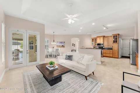 a living room with furniture and large windows