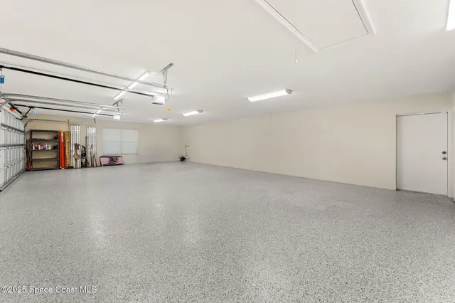 a view of a livingroom with a ceiling fan and window