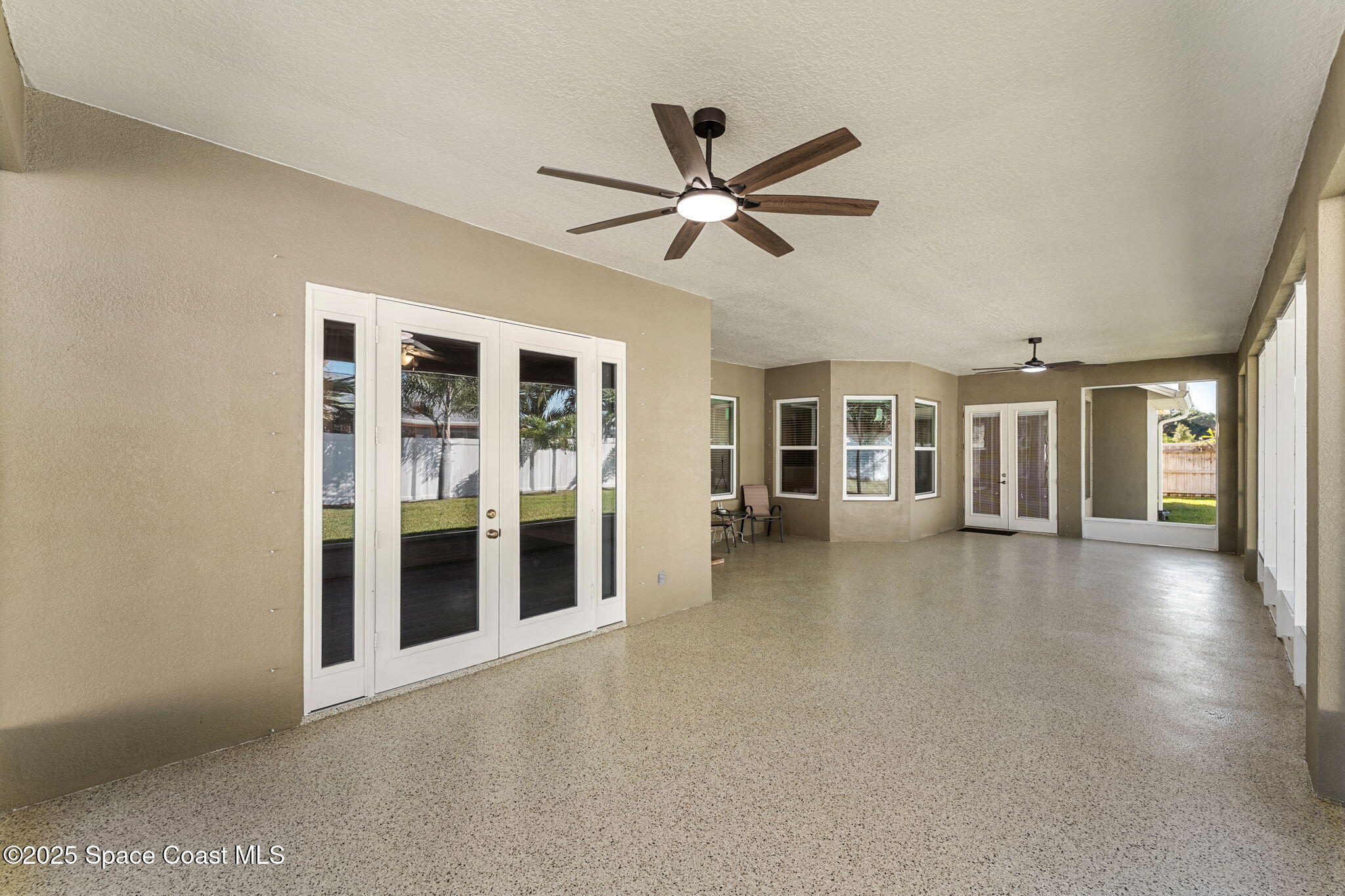1239 Guy Island Drive Merritt Island, FL 32952 - Photo 27 of 42 a view of a livingroom with a ceiling fan and window