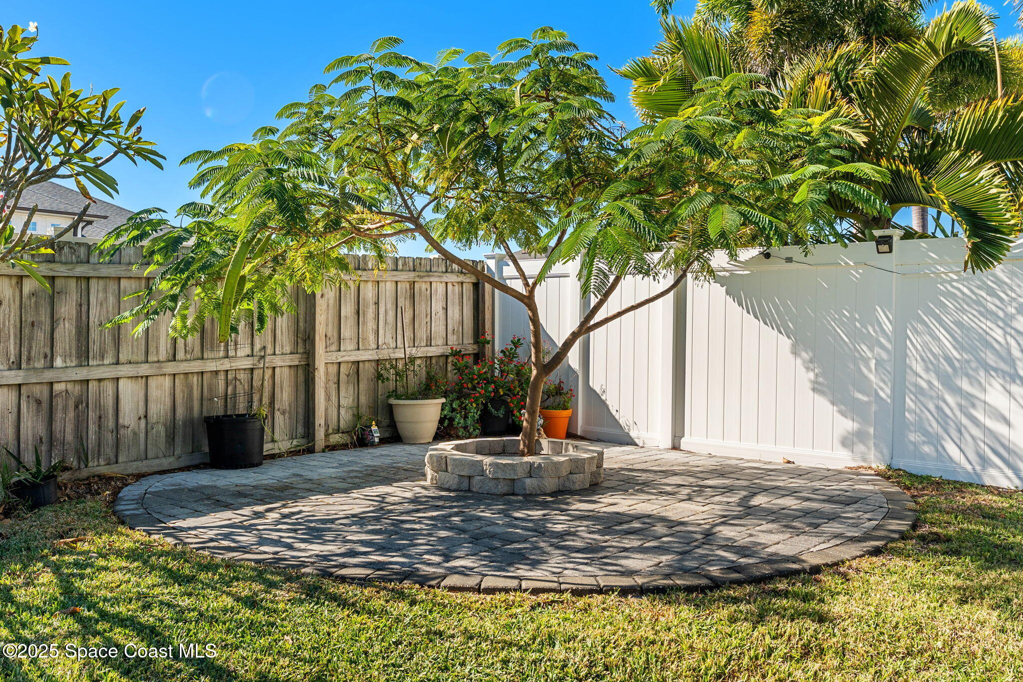 1239 Guy Island Drive Merritt Island, FL 32952 - Photo 30 of 42 a view of a house with a tree and wooden fence