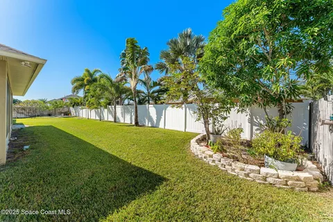 a view of a house with a yard and lake view