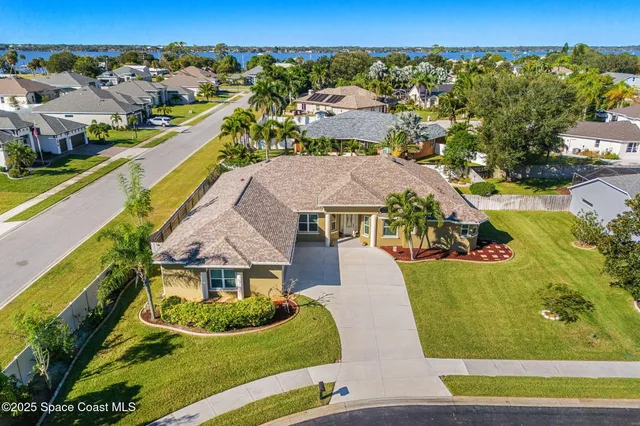 an aerial view of a house with a swimming pool