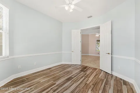 a view of a room with wooden floor and white walls