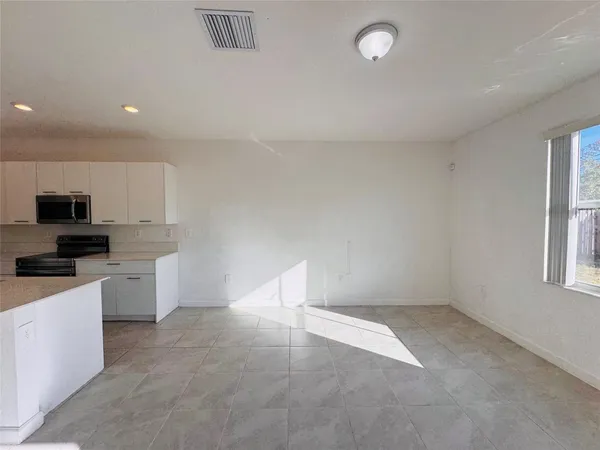 a kitchen with cabinets and window