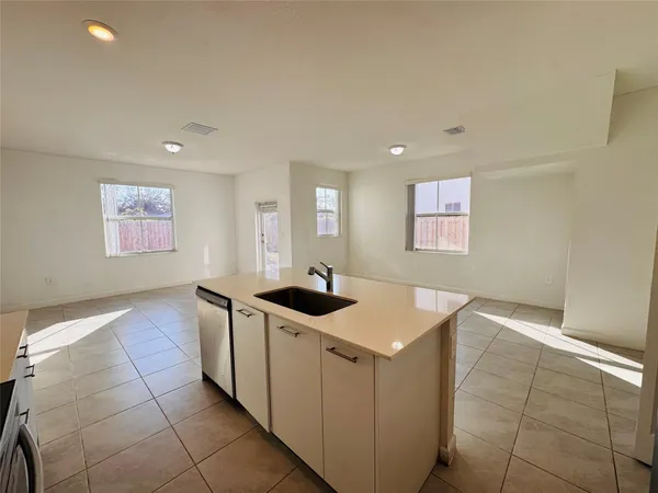 a kitchen with a stove and white cabinets