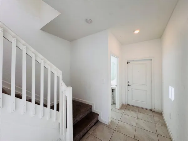 a view of a hallway with white doors