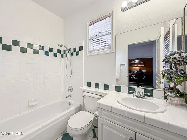 a view of a house with swimming pool and sitting area