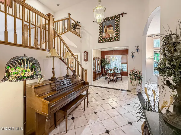 a living room with stainless steel appliances kitchen island granite countertop furniture and a fireplace