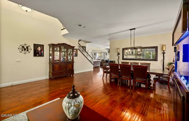 a dining room with furniture entryway and wooden floor