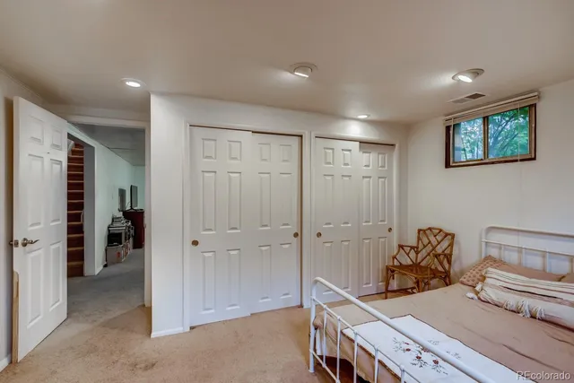 a hallway with a couch and a cabinet with wooden floor
