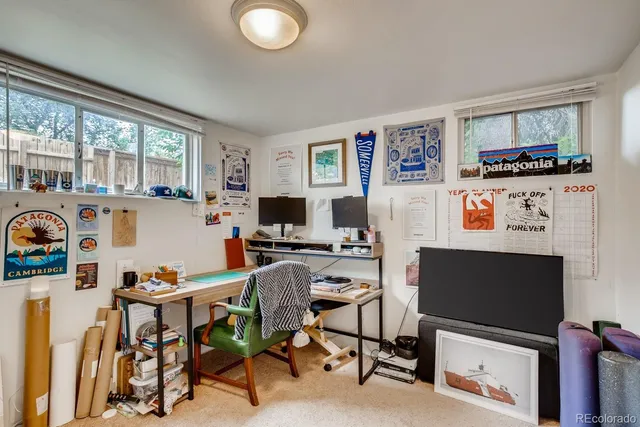 a view of a workspace with furniture and a flat screen tv