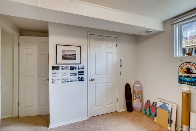 a view of a kitchen with refrigerator and window