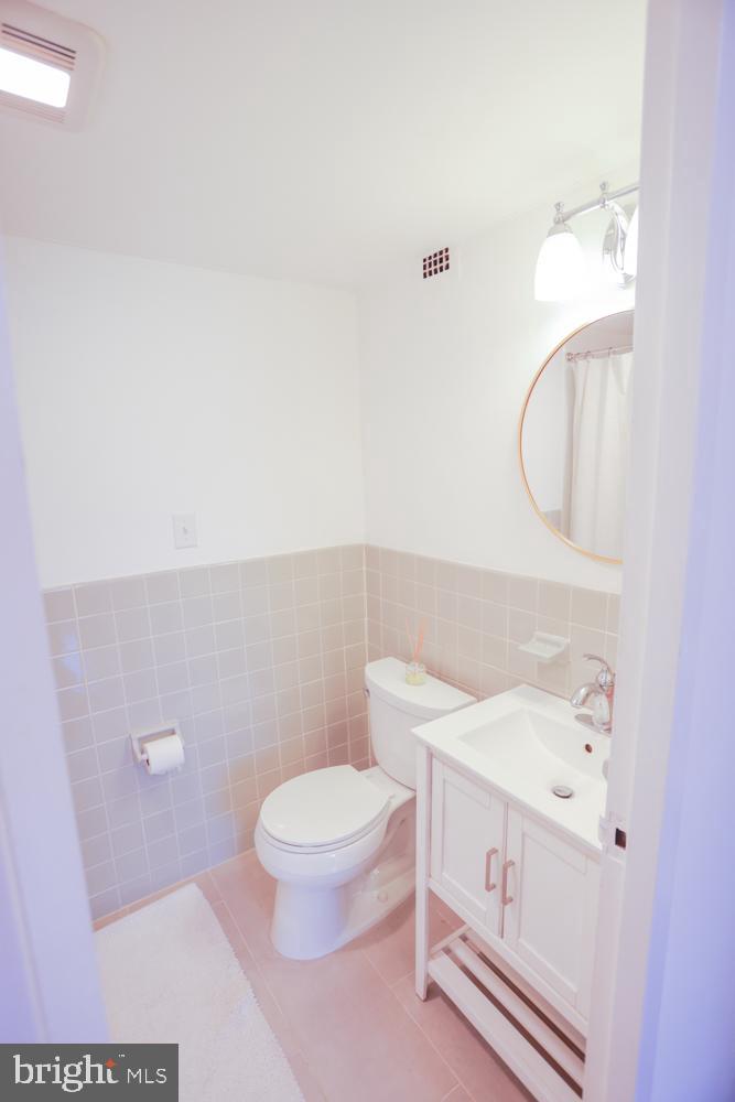 5406 Connecticut Avenue Northwest, Unit 803 Washington, DC 20015 - Photo 14 of 19 a white toilet sitting next to a bathroom sink