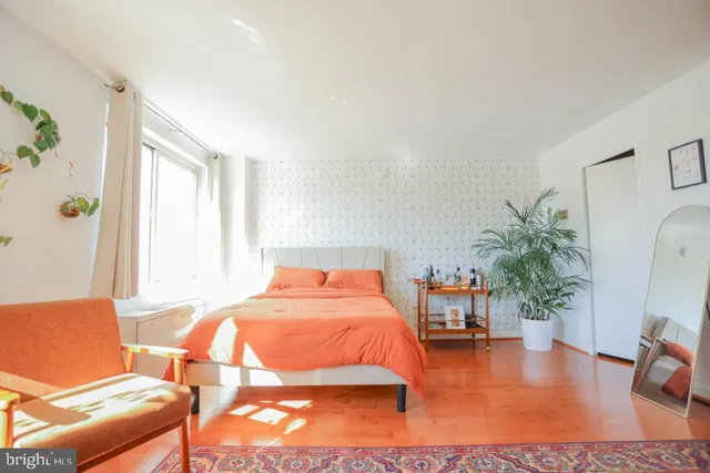 a bedroom with a bed and a window