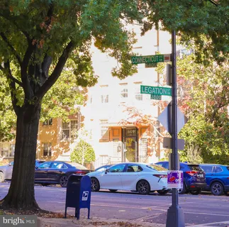 a view of a patio with couches and table and chairs with wooden fence