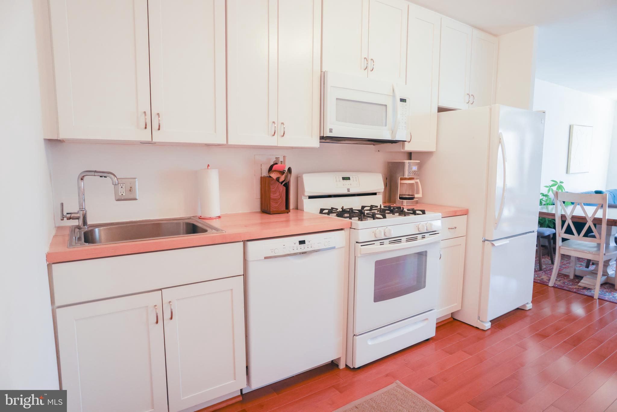5406 Connecticut Avenue Northwest, Unit 803 Washington, DC 20015 - Photo 5 of 19 a kitchen with white cabinets and white appliances