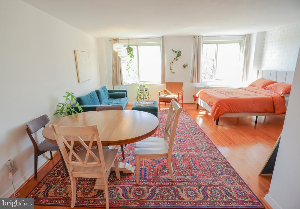 5406 Connecticut Avenue Northwest, Unit 803 Washington, DC 20015 - Photo 7 of 19 a dining room with furniture and wooden floor