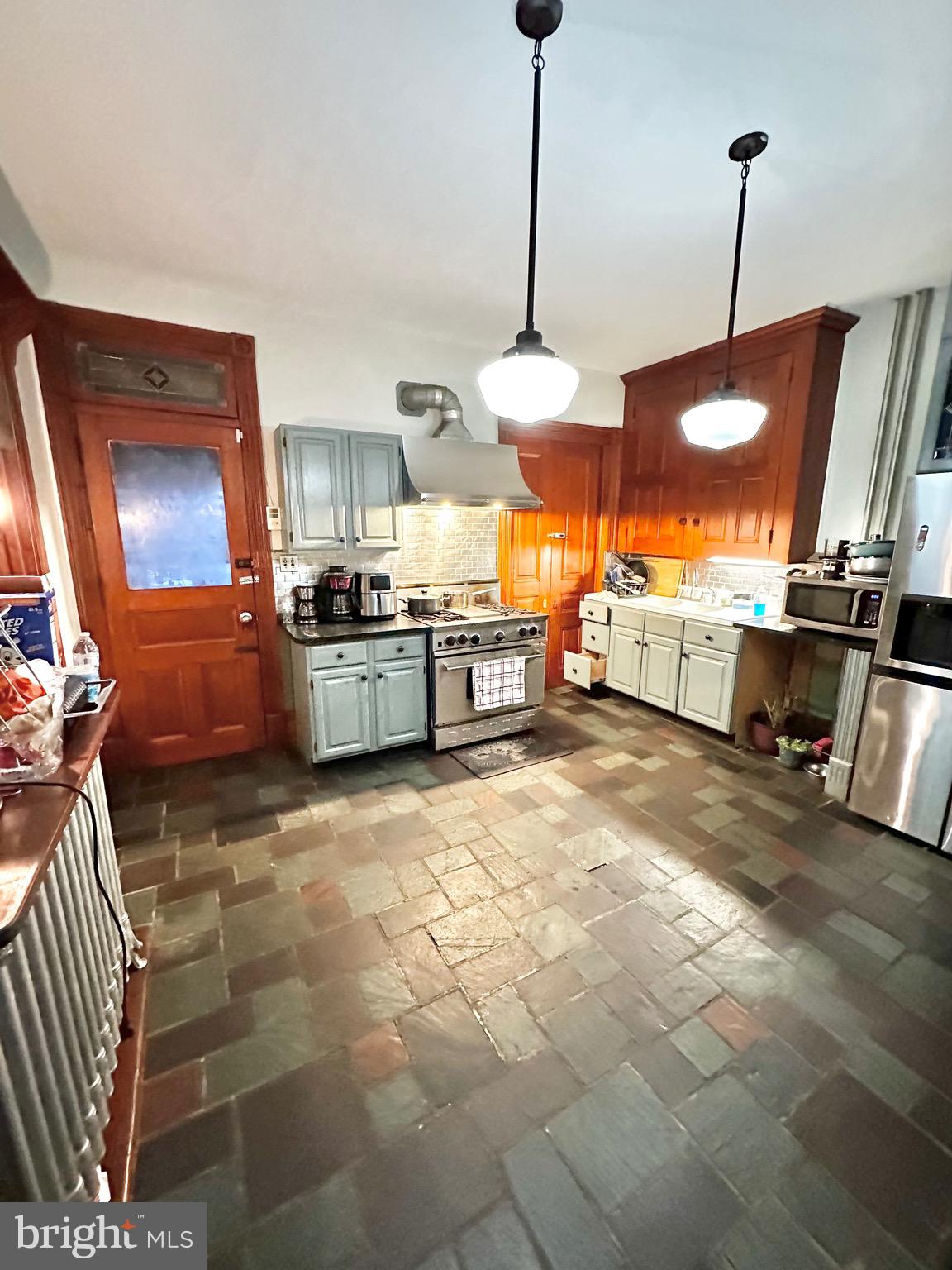 1396 Perkiomen Avenue Reading, PA 19602 - Photo 11 of 45 a kitchen with stainless steel appliances granite countertop a stove a sink and a refrigerator