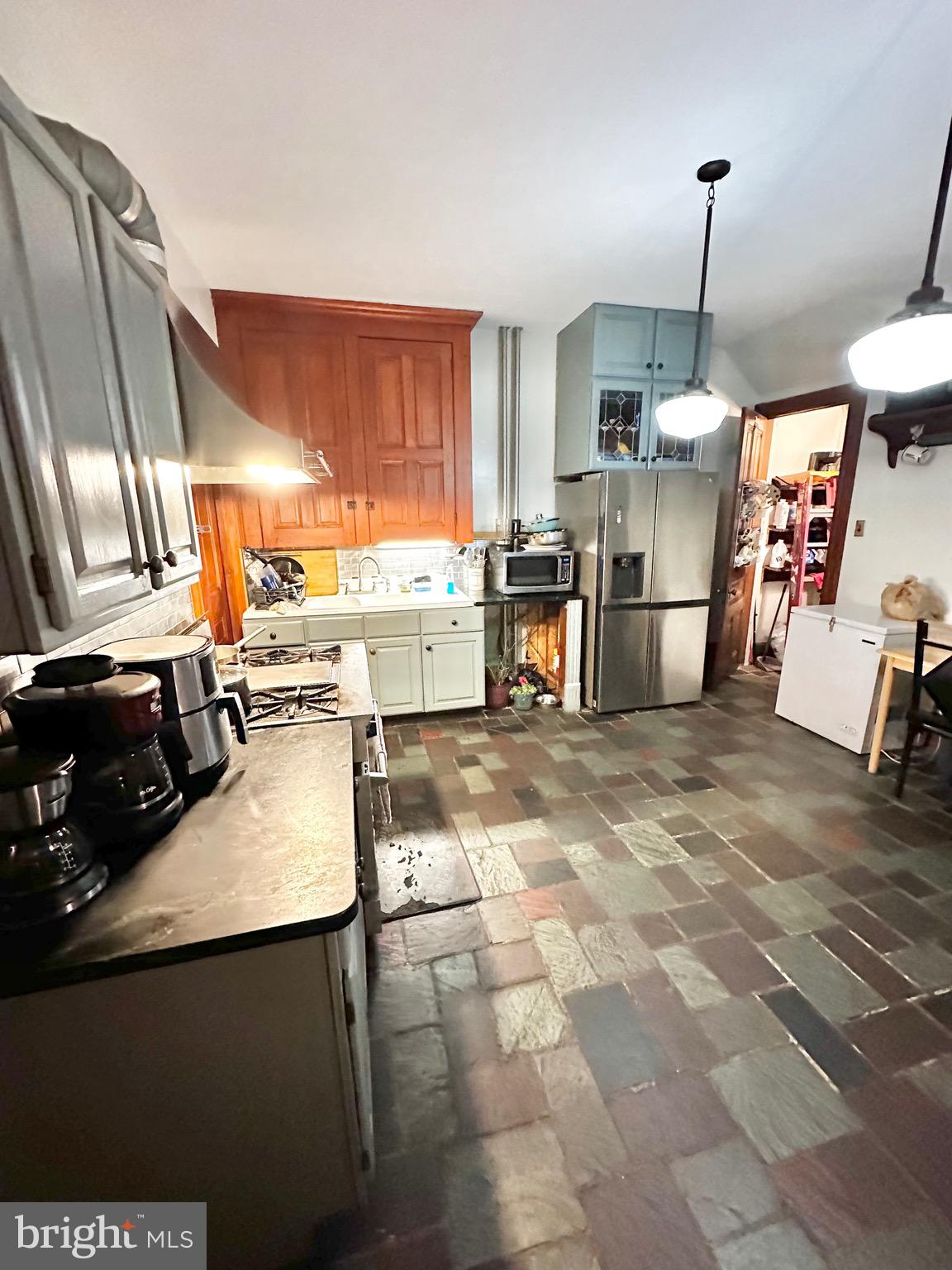 1396 Perkiomen Avenue Reading, PA 19602 - Photo 12 of 45 a kitchen with stainless steel appliances granite countertop a sink a stove and a refrigerator