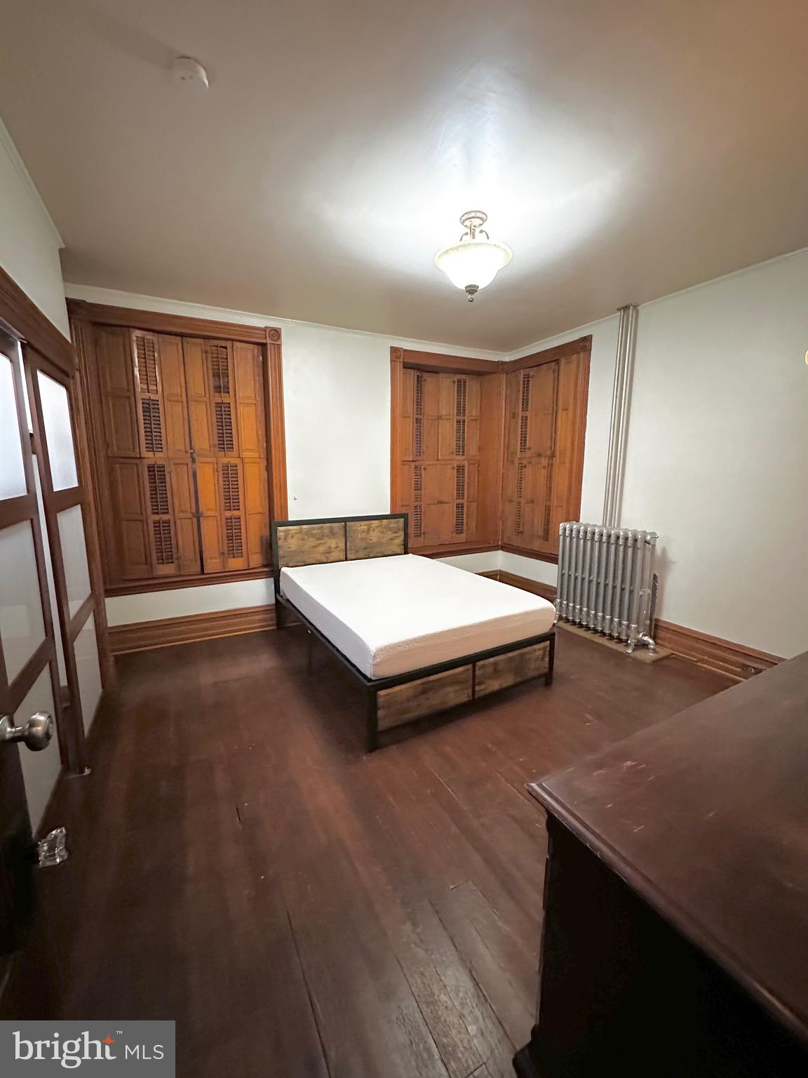 1396 Perkiomen Avenue Reading, PA 19602 - Photo 17 of 45 a bedroom with a bed and wooden floor