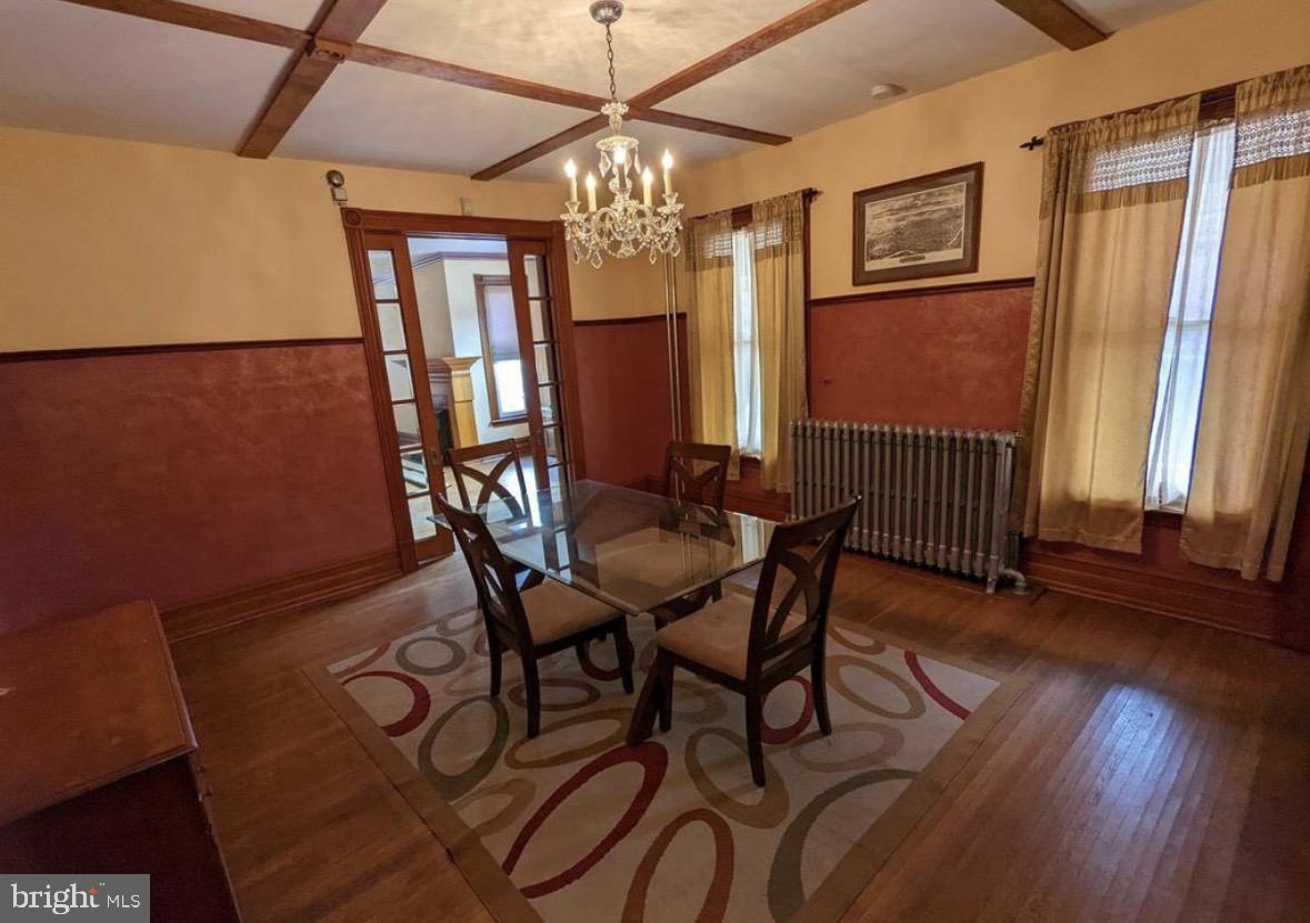 1396 Perkiomen Avenue Reading, PA 19602 - Photo 10 of 45 a dining room with furniture a chandelier and wooden floor