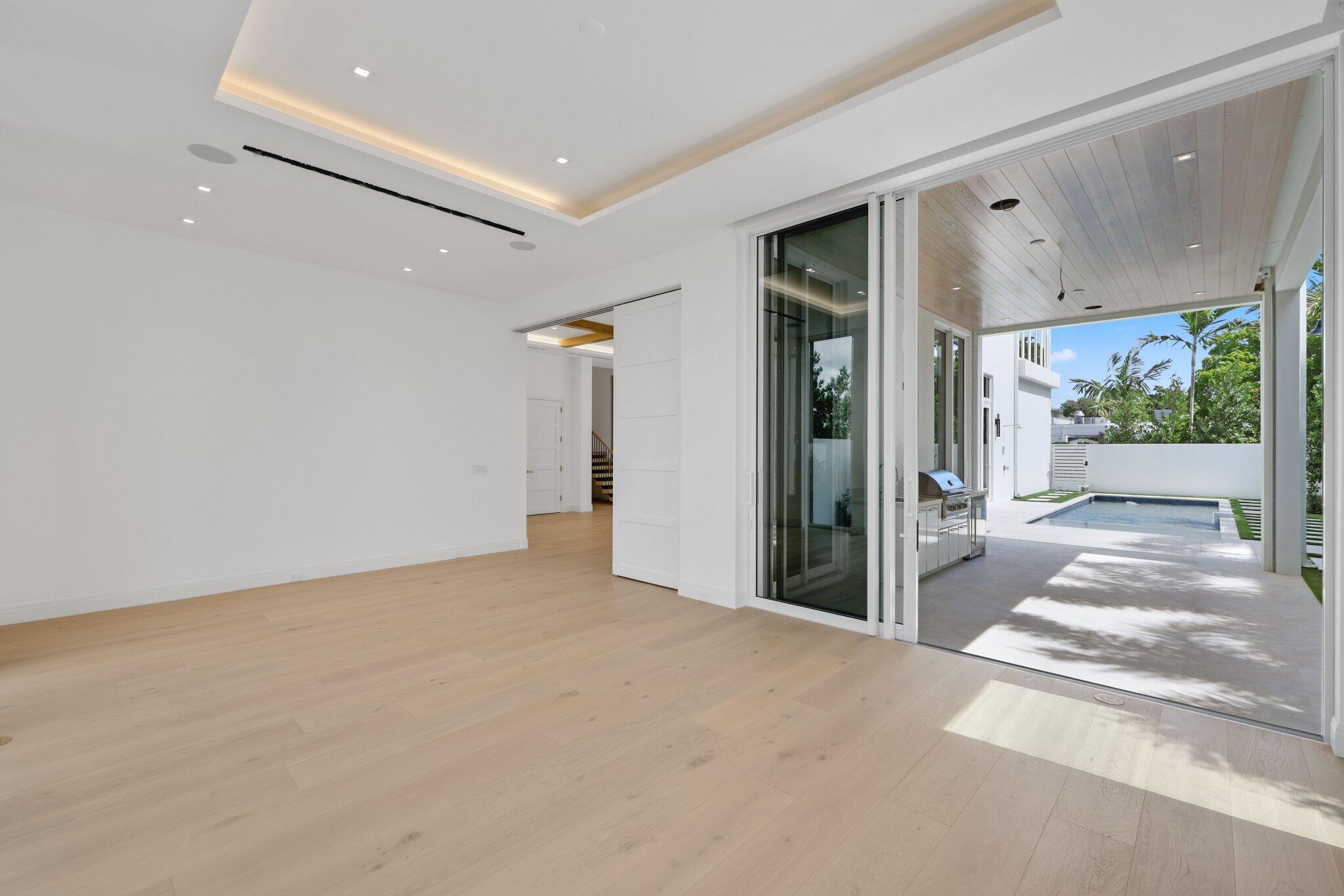 320 Grove Place Delray Beach, FL 33444 - Photo 21 of 85 a view of a hallway with wooden floor and a living room