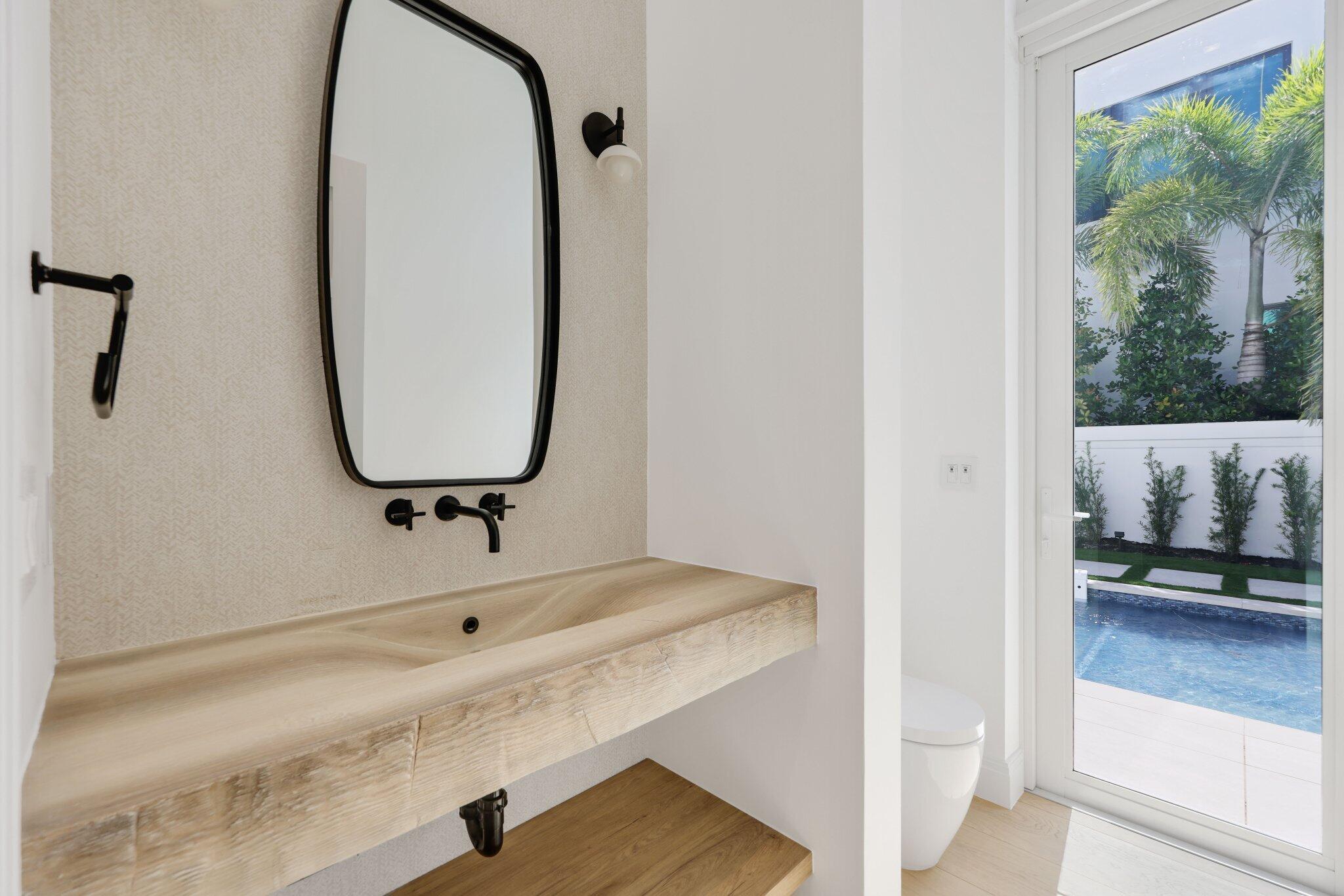 320 Grove Place Delray Beach, FL 33444 - Photo 30 of 85 a bathroom with a sink and a mirror