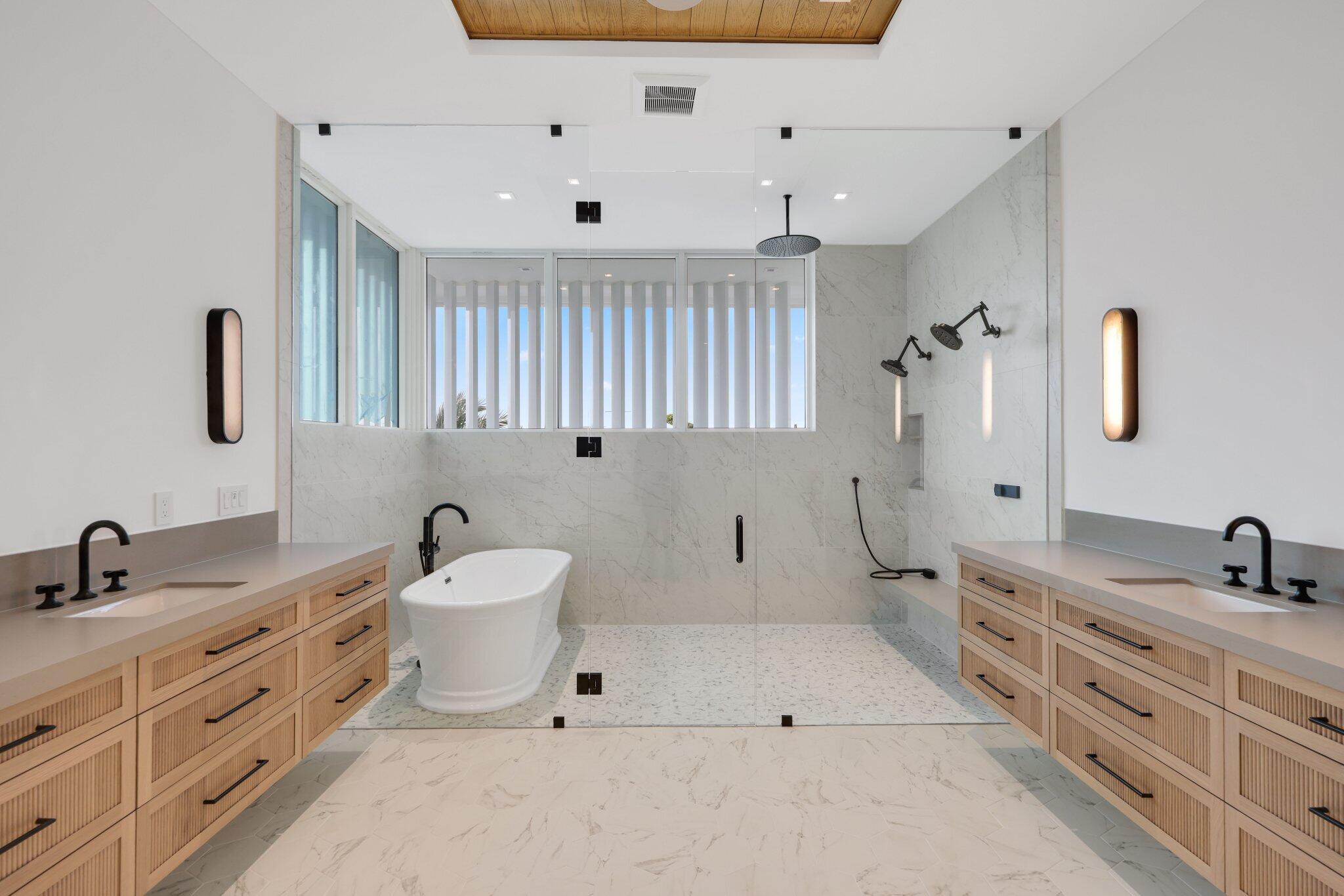 320 Grove Place Delray Beach, FL 33444 - Photo 38 of 85 a bathroom with a double vanity sink a mirror and a bathtub