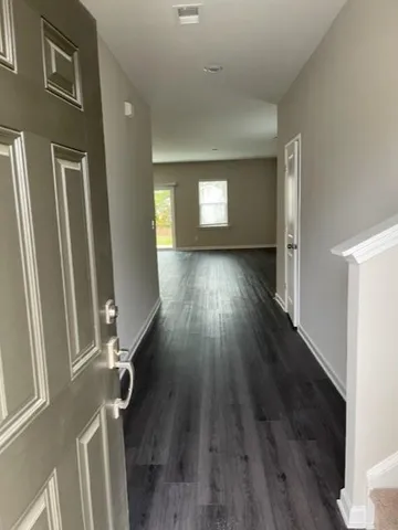 a view of a room with wooden floor and window