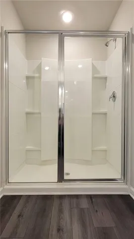 a bathroom with a glass shower door