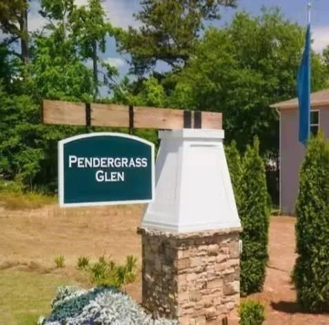 a sign board with buildings in the background