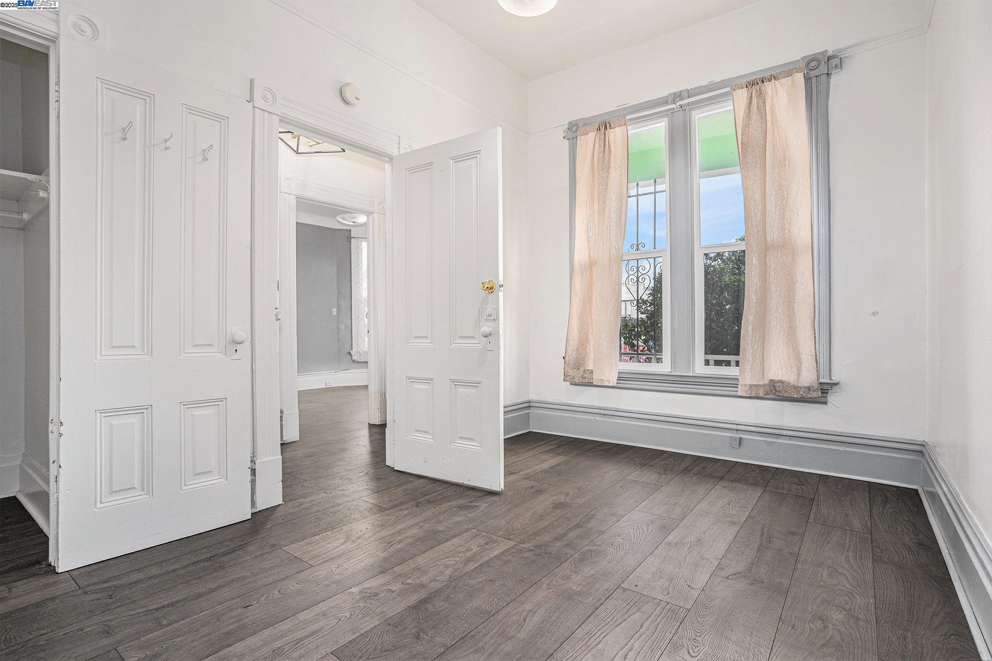 185 7th Street Oakland, CA 94607 - Photo 13 of 20 a view of empty room with wooden floor and fan