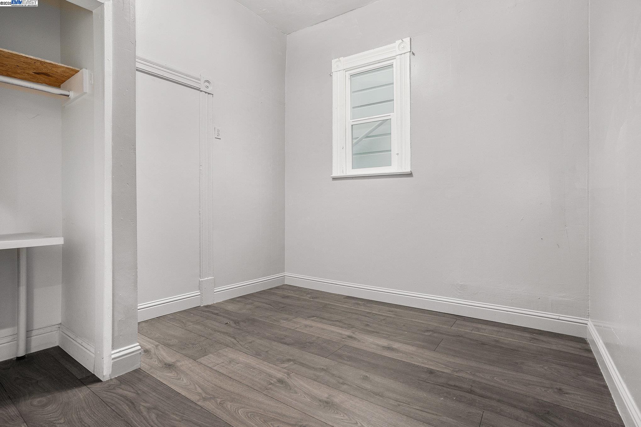 185 7th Street Oakland, CA 94607 - Photo 15 of 20 an empty room with wooden floor and windows