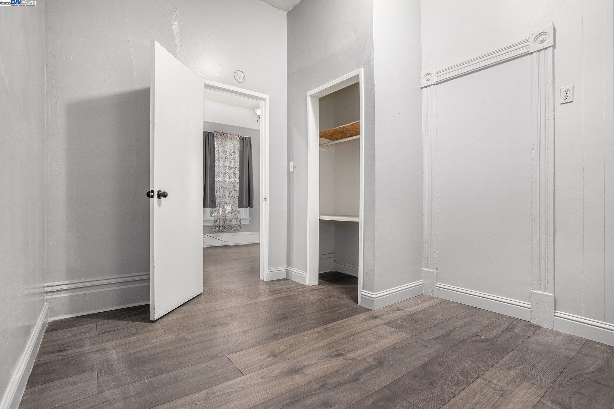 185 7th Street Oakland, CA 94607 - Photo 16 of 20 an empty room with wooden floor and closet