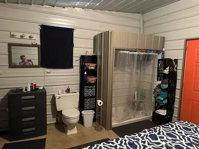 a bathroom with a toilet and a shower