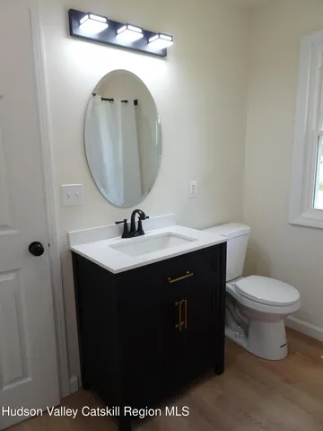 a bathroom with a sink vanity and a mirror