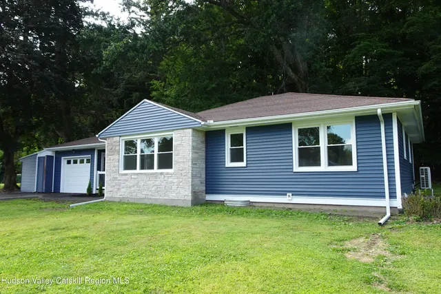 a front view of a house with a garden
