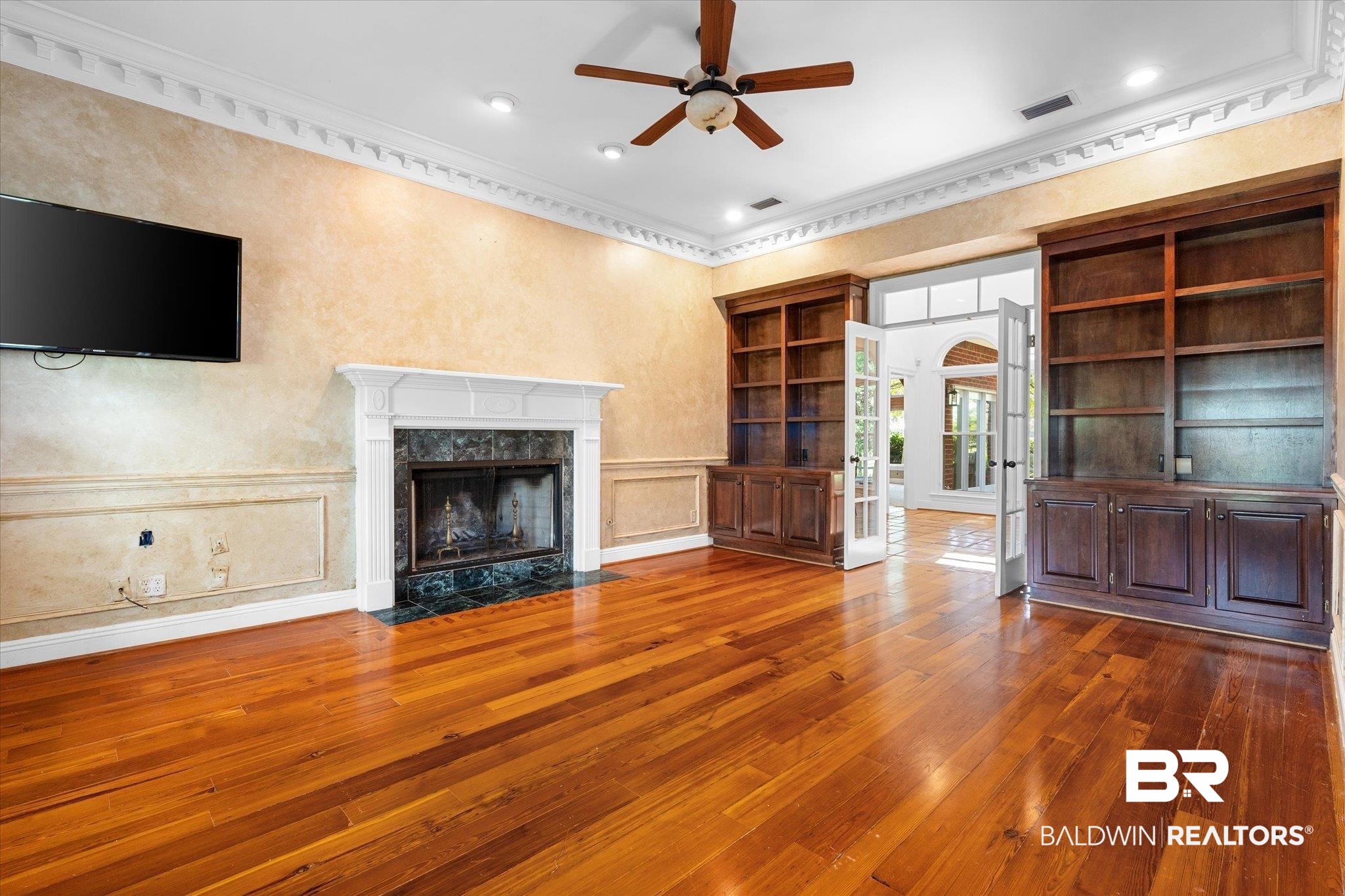 5231 Dawes Road Grand Bay, AL 36541 - Photo 4 of 49 Unfurnished living room with a high end fireplace, dark wood-type flooring, built in shelves, crown molding, and ceiling fan