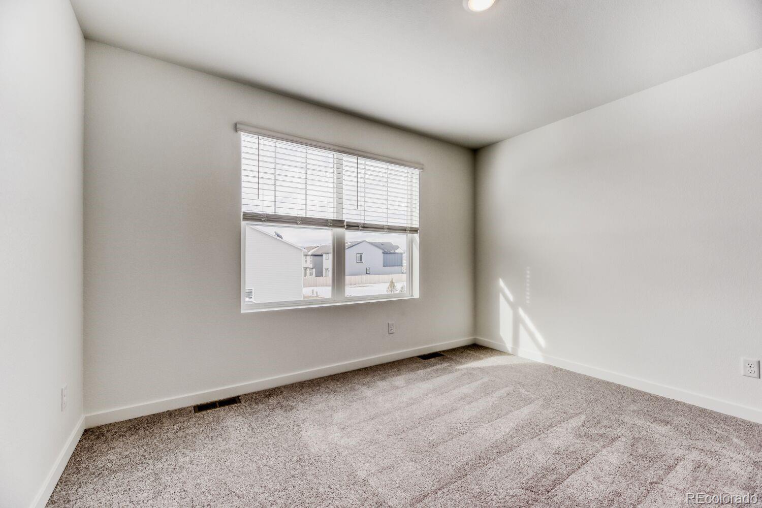 8962 Blue Feather Loop Colorado Springs, CO 80908 - Photo 11 of 18 an empty room with a window