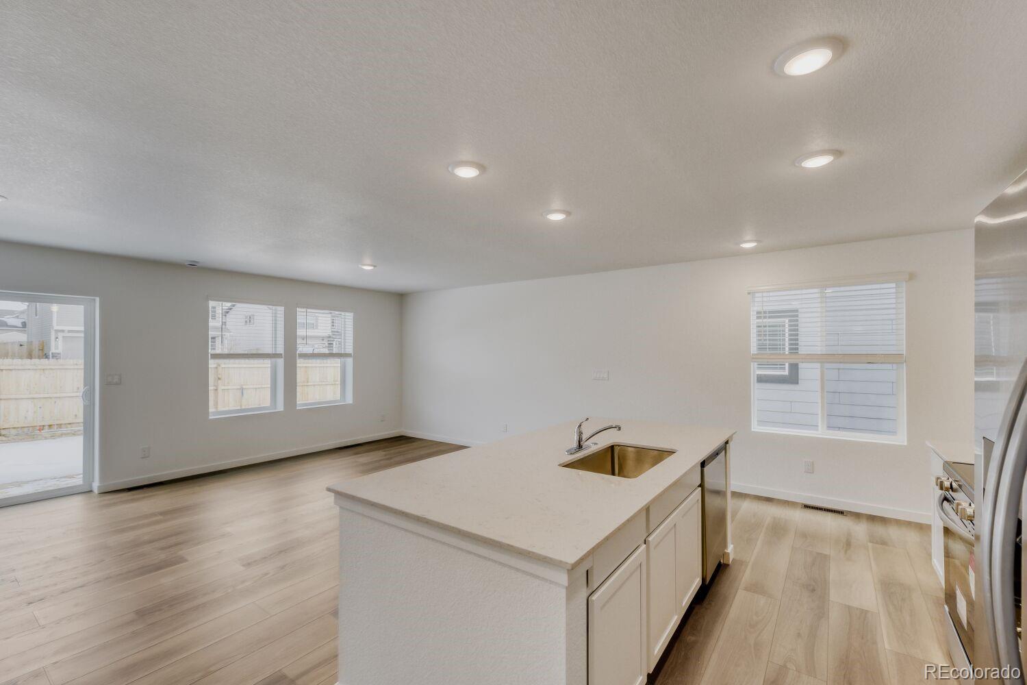 8962 Blue Feather Loop Colorado Springs, CO 80908 - Photo 4 of 18 a view of an empty room with wooden floor and a window